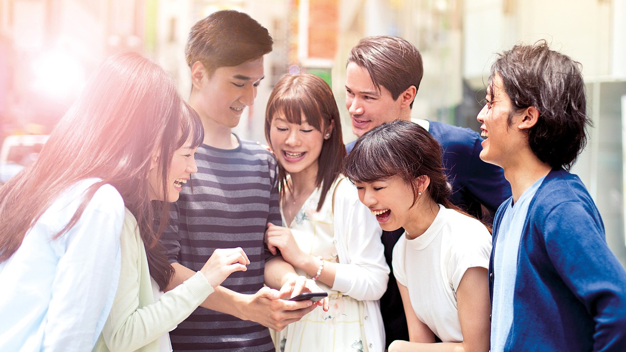 Group of young people with smart phone; image used for at your integrated account service 24/7.
