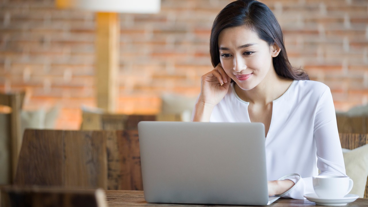 A woman is using her laptop