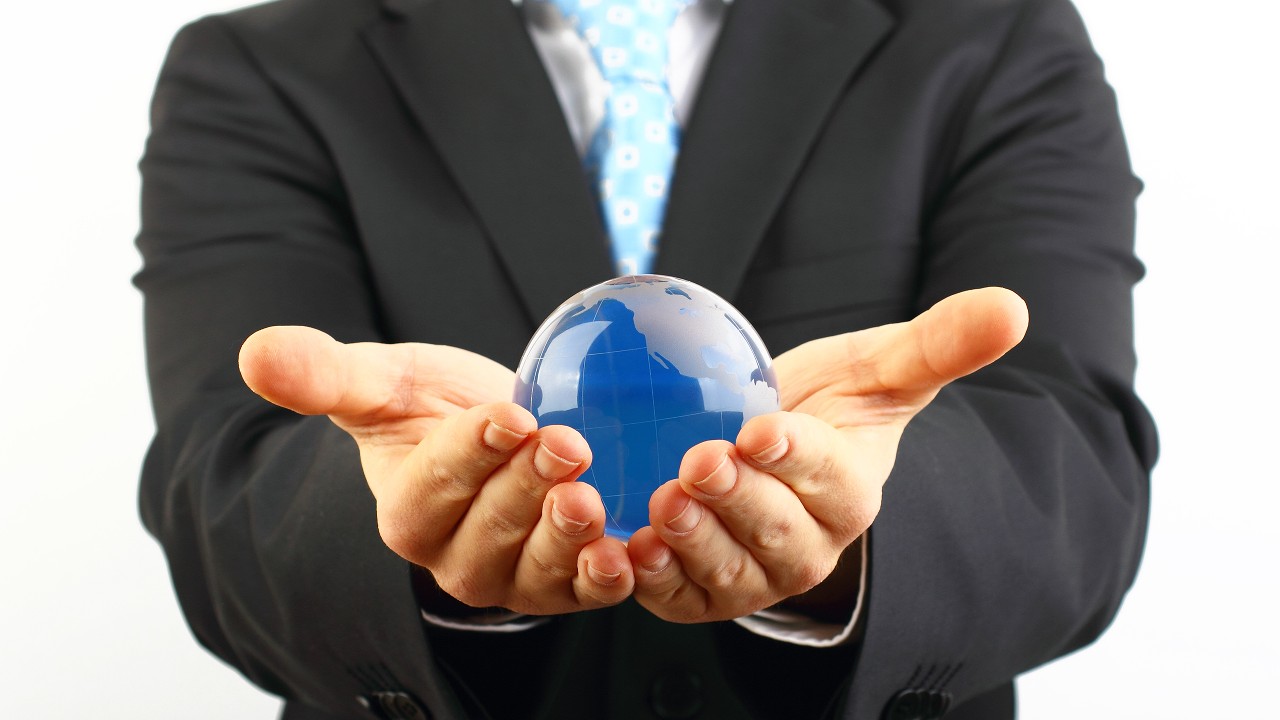 A business man holding a globe made by glass; image used for  Over-the-counter Traded Debt Securities / Certificates of Deposit (CDs)