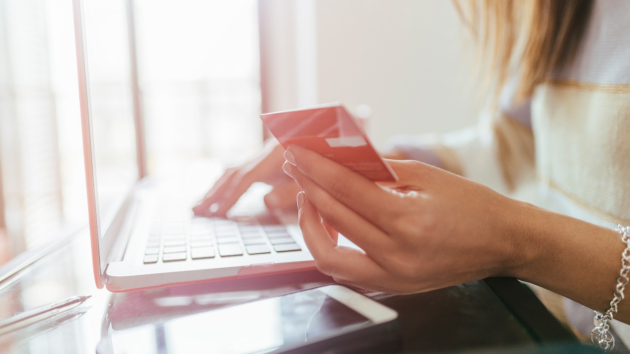 A lady is shopping online and paying by using her credit card; image used Rack up online spending offers with your HSBC Red Credit Card.