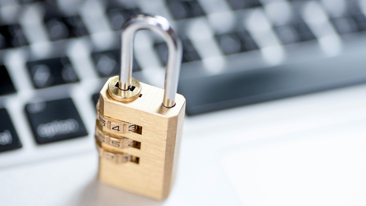 A gold color lock next to the keyboard; image used for HSBC cyber security index.