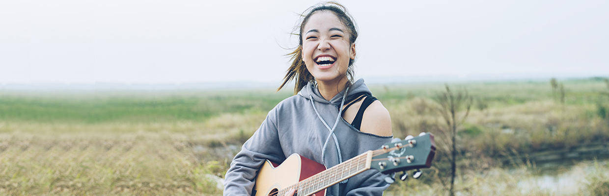 A woman playing guitar; image used for HSBC Accounts Article.