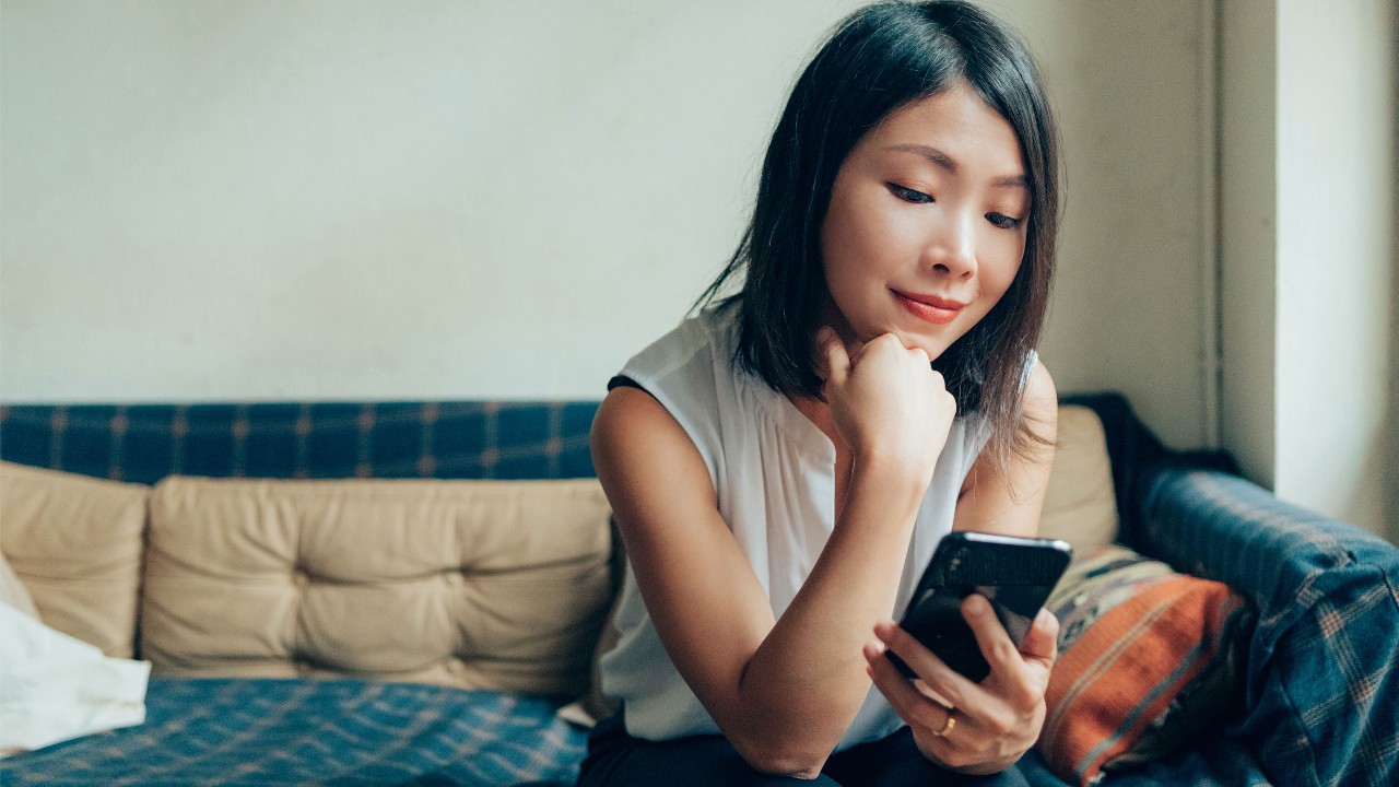 woman holding a phone and planning in mind